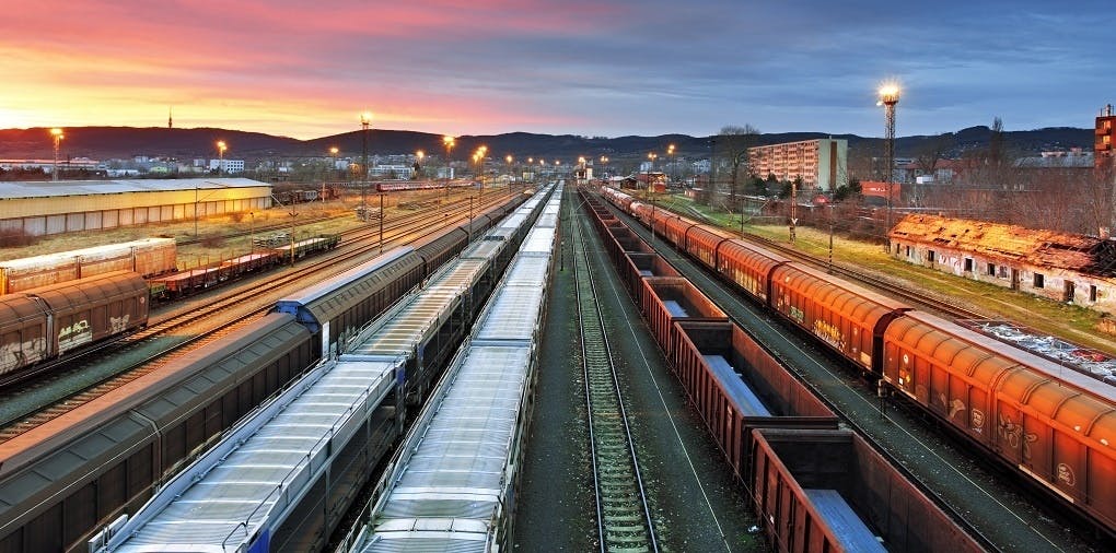 Freight trains at a station at dusk